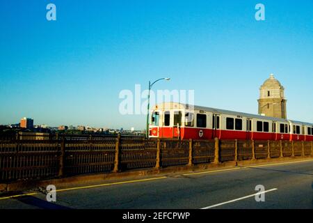 Train moving on tracks along a road, Longfellow Bridge, Boston, Massachusetts, USA Stock Photo