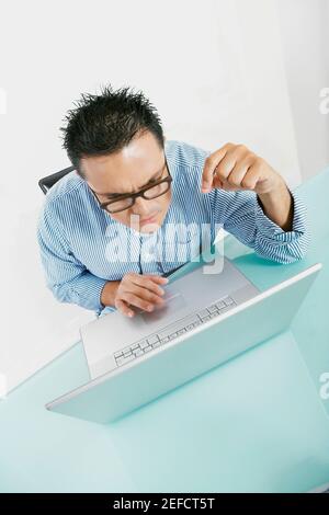 High angle view of a mid adult man working on a laptop Stock Photo