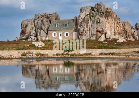 House Between Two Rocks, Le Gouffre du Castel-Meuru, Plougrescant, near Treguier, Cote de Granit Rose, Brittany, France Stock Photo