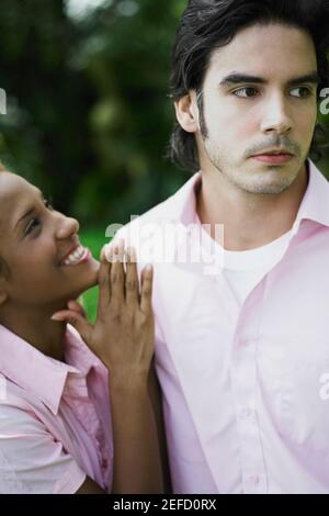 Side profile of a young woman pleading to a young man Stock Photo