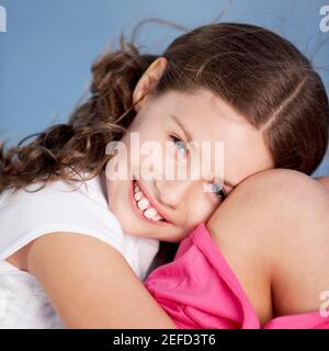 Close-up of a girl hugging her knees Stock Photo