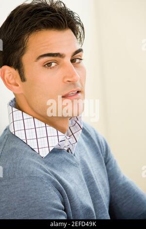 Portrait of a mid adult man leaning against a wall Stock Photo