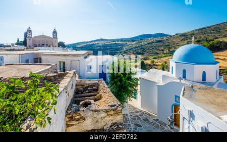 Typical whitewashed church with blue dome on the corner of the street, Lefkes, Paros island, Greece Stock Photo