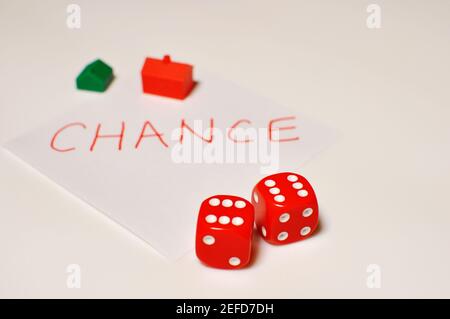 Concept of 2 red dice in foreground and the word chance written by hand in background with copy text Stock Photo