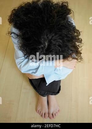 upset woman hugging knees and sitting on bed at home Stock Photo - Alamy