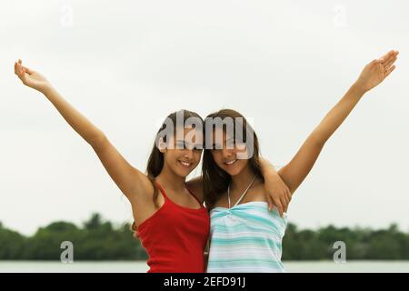 Portrait of two teenage girls with their arms around each other Stock Photo