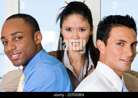 Close-up of two businessmen with a businesswoman Stock Photo