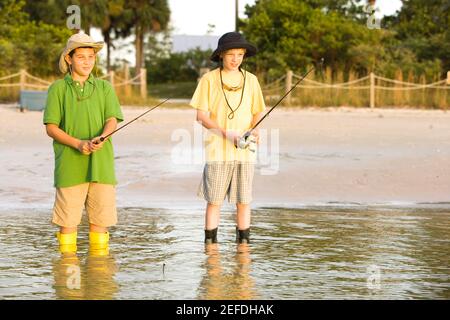 Close-up of a teenage boy holding a fishing rod - Stock Photo