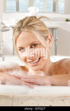 Portrait of a young woman in a bathtub Stock Photo
