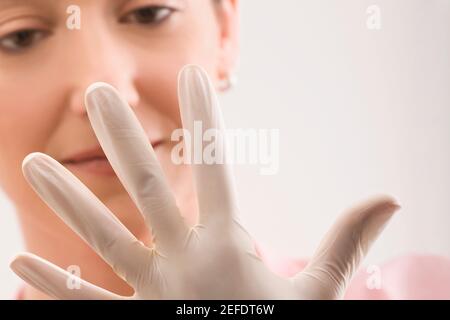 Female doctor wearing a surgical glove Stock Photo