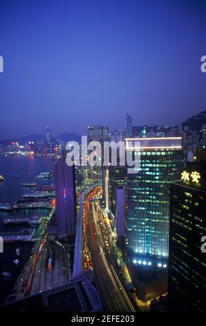 High angle view of buildings in a city lit up at night, Hong Kong, China Stock Photo