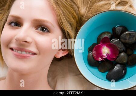 Portrait of a teenage girl lying on a massage table and smiling Stock Photo