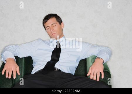 Close up of a businessman napping in an armchair Stock Photo