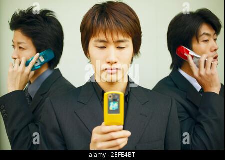 Three businessmen using mobile phones Stock Photo