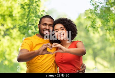 happy african american couple making hand heart Stock Photo