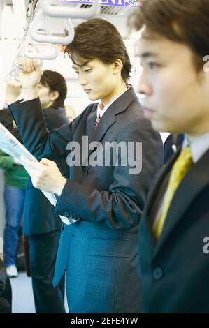 Side profile of a businessman traveling in a train Stock Photo