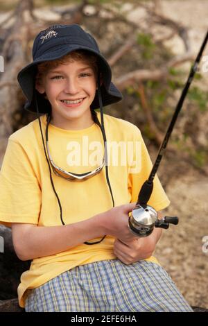 Close-up of a teenage boy holding a fishing rod Stock Photo