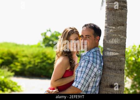 Portrait of a mid adult man and a young woman embracing each other Stock Photo