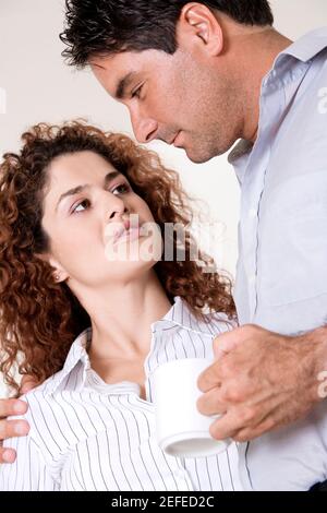 Close-up of a young woman and a mid adult man Stock Photo