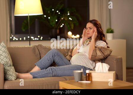 sick pregnant woman having headache at home Stock Photo