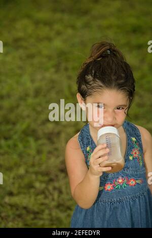 1, one, Hispanic girl, baby girl drinking from baby bottle, toddler, Castro  Valley, Alameda County, California, United States, North America Stock  Photo - Alamy