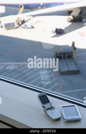 High angle view of a mobile phone and a personal data assistant Stock Photo