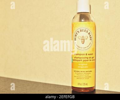 Close up of a honey shower gel bottle for baby on yellow background with copy text.  Natural product Stock Photo