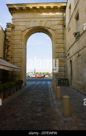 Traffic on road viewed through an arch, Porte de la Monnaie, Vieux Bordeaux, Bordeaux, France Stock Photo