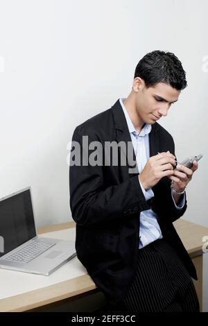 High angle view of a businessman using a personal data assistant Stock Photo