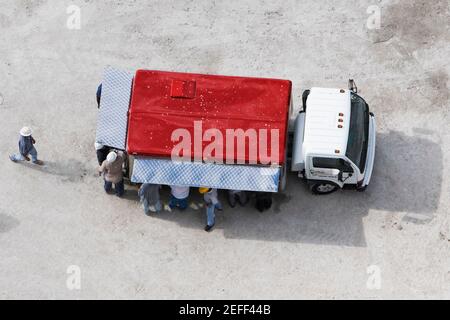 High angle view of construction workers standing near a semi truck Stock Photo