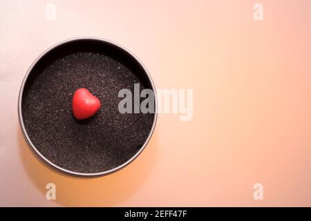 Close-up of a heart shaped candy in a bowl Stock Photo