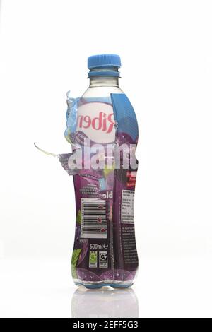 Images of plastic sleeves on single use drink bottles are not yet recyclable and should be peeled off but how many people know this or do it. Stock Photo