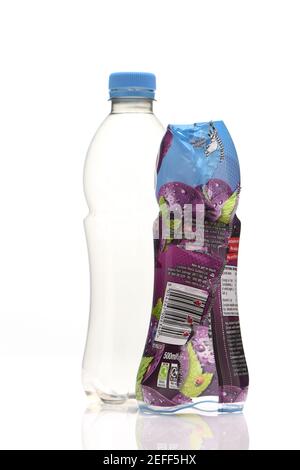 Images of plastic sleeves on single use drink bottles are not yet recyclable and should be peeled off but how many people know this or do it. Stock Photo