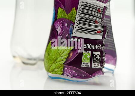 Images of plastic sleeves on single use drink bottles are not yet recyclable and should be peeled off but how many people know this or do it. Stock Photo
