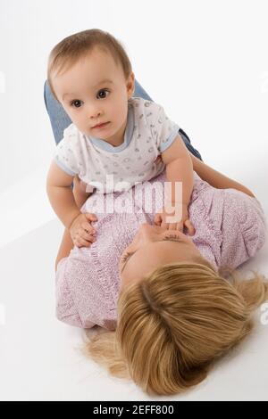 Close up of a mid adult woman playing with her baby boy Stock Photo