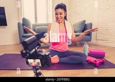 Attractive Woman personal trainer coach recording on camera new content for online fitness business. Freelance filming online training program with vi Stock Photo