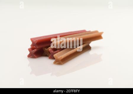 Dog teeth chews for cleaning teeth and healthy mouths. Photographed on a white background with reflection. Dentastix range from Pedigree Stock Photo