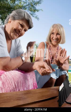 Two women playing mahjong Stock Photo