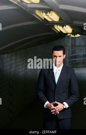 Businessman standing in a subway and thinking Stock Photo