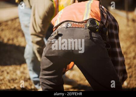 Close-up of two construction workers working at a construction site Stock Photo