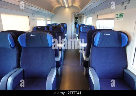 Rome, Italy - May 19, 2017:Empty train interior seats during travel. Euro star high speed train of Trenitalia major italian railway company.