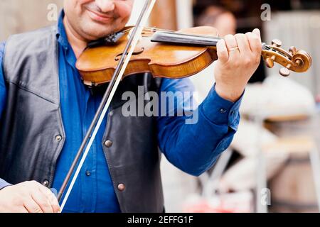 Close-up of a violinist playing a violin Stock Photo