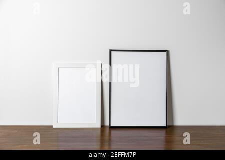 White and black two wooden Photo or poster frames mock up on table. Minimal Stock Photo