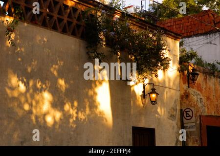Lantern lit up on the wall of a building, Mexico Stock Photo