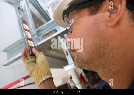 Close-up of a male construction worker using a spirit level Stock Photo