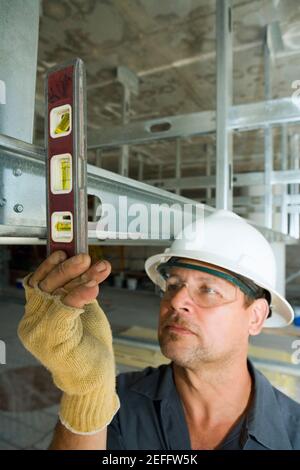 Close-up of a male construction worker using a spirit level Stock Photo