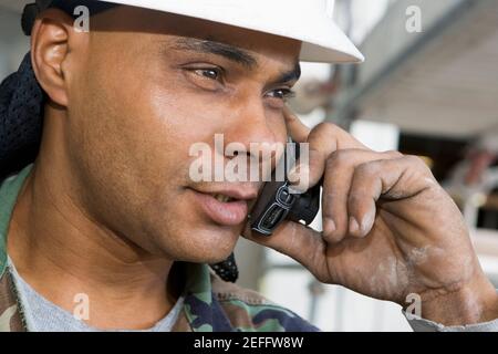Close-up of a male construction worker talking on a mobile phone Stock Photo