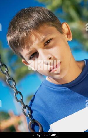 Portrait of a teenage boy on a swing Stock Photo