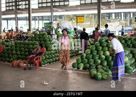 YANGON, MYANMAR - DECEMBER 31 2019: Huge piles of fresh watermelons at a local street market in Myanmar Stock Photo