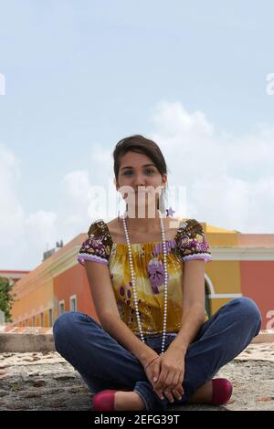 Portrait of a young woman sitting with cross-legged Stock Photo
